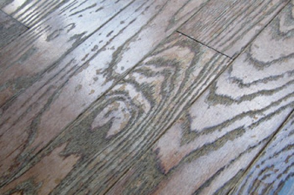 Prefinished solid wood floor damaged by repeated use of a steam mop cleaner