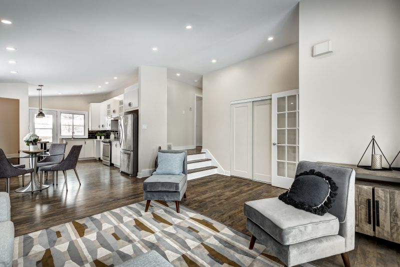 open layout kitchen and living space with dark hardwood flooring and gray furniture