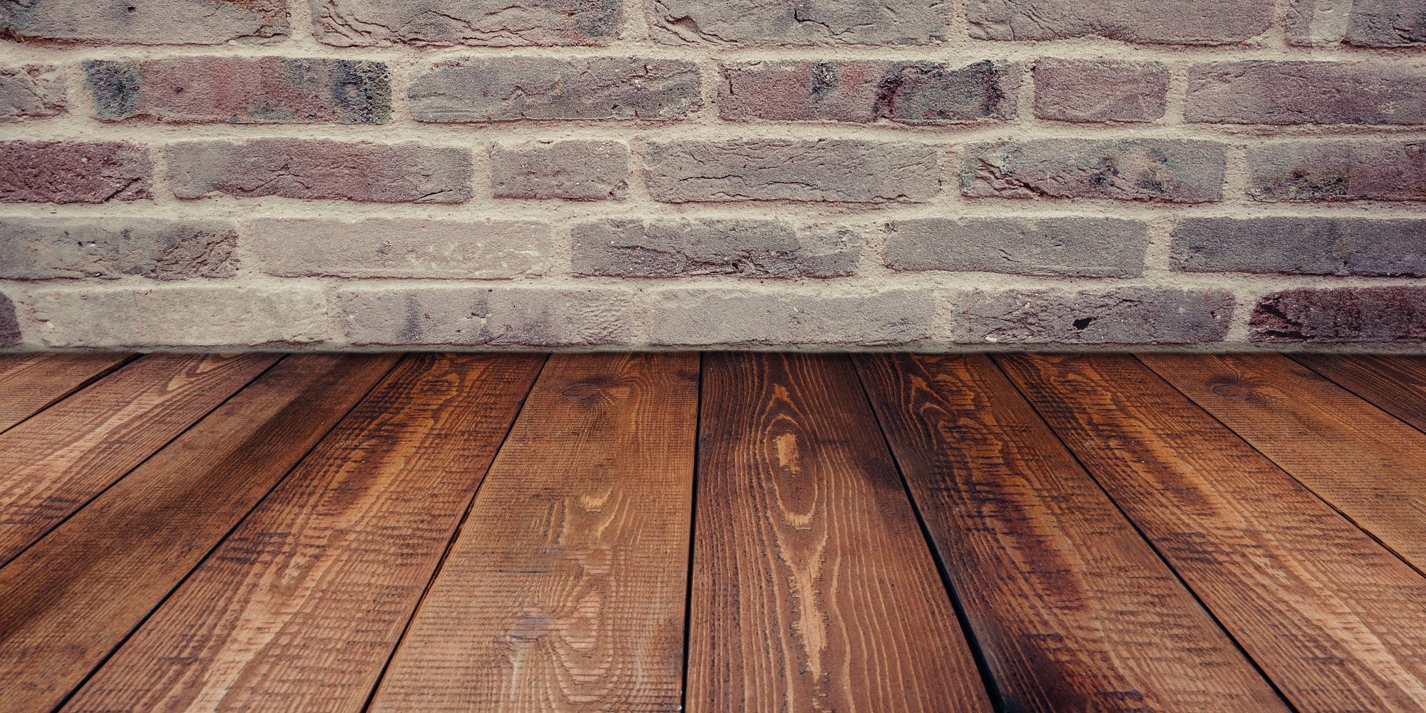 hardwood floor and brick wall