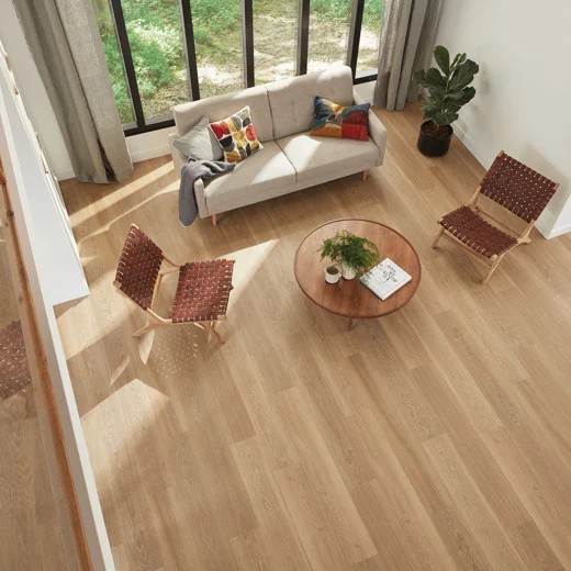 top view of warm vinyl plank flooring in a living area with a couch and two chairs